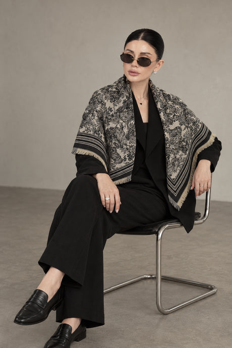BLACK cashmere animal print square shawl folded into a triangle — seated