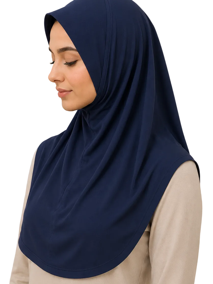 Woman wearing a navy hijab against a beige background